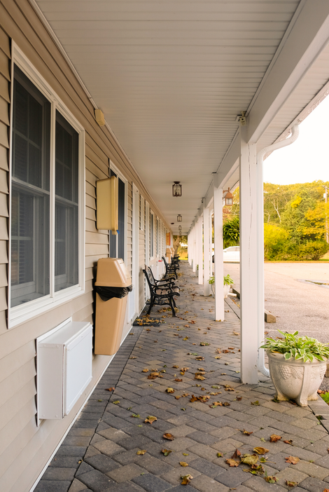 Benches and floating trashcans accompany each room of the Seabreeze Motel.